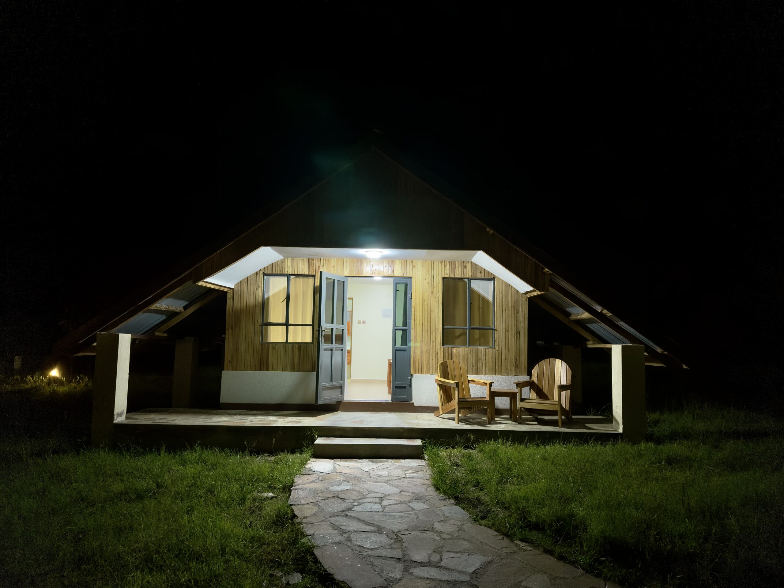 Elegant bed with garden views in a tent at Olorien Mara Camp, Kenya.