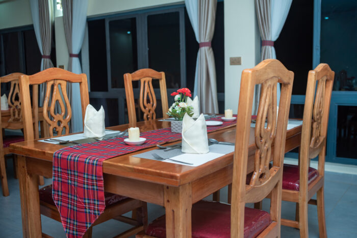 Modern kitchen at Olorien Mara Camp, Masai Mara, Kenya, with chefs preparing meals.